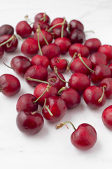 bunch ripe cherries on white marble