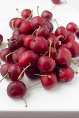 bunch ripe cherries on white marble