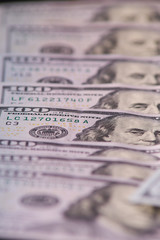 a pile of American paper hundred-dollar bills as an element of the world financial system. Selective focus