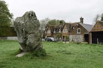 Part of the neolithic stone circle in Avebury, Wiltshire, United Kingdom. Part of the village in...