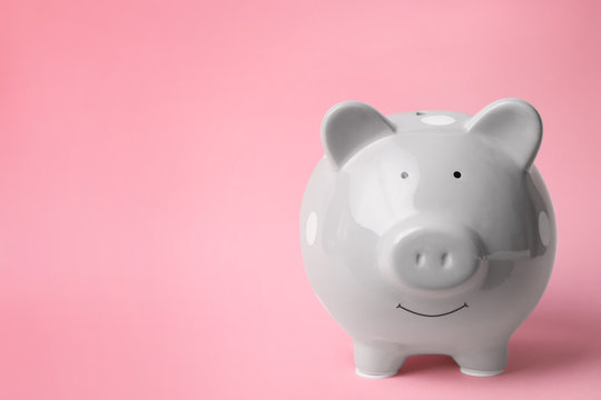 Gray piggy bank on color background. Money saving