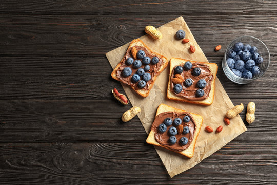 Toast bread with chocolate spread and blueberry on dark background