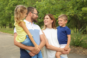 Fototapeta premium Happy family spending time together with their children outdoors