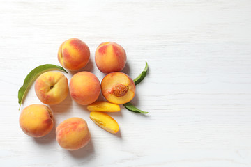 Fresh sweet peaches on wooden table, top view