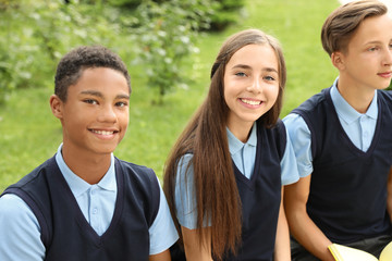 Teenage students in stylish school uniform outdoors