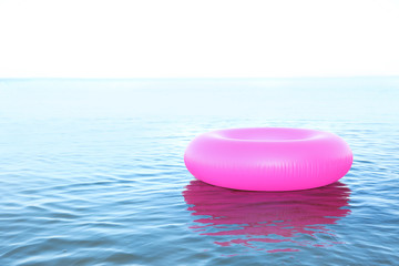 Inflatable ring floating on sea water. Summer vacation