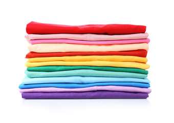 Stack of colorful t-shirts on white background