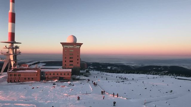Aerial view of the Brocken peak in the Harz mountains in winter during sunset