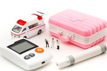 Miniature people : Doctor and patient with Glucose meter diabetes test and Syringe with measuring tape,concept of diabetes, healthy lifestyles and nutrition