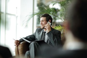 close up. handsome businessman talking on smartphone