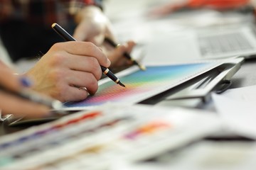 close up.a group of designers discuss the color palette