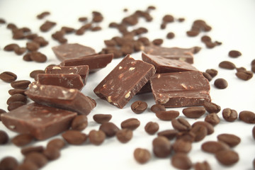 close up.pieces of chocolate and coffee beans isolated on white.