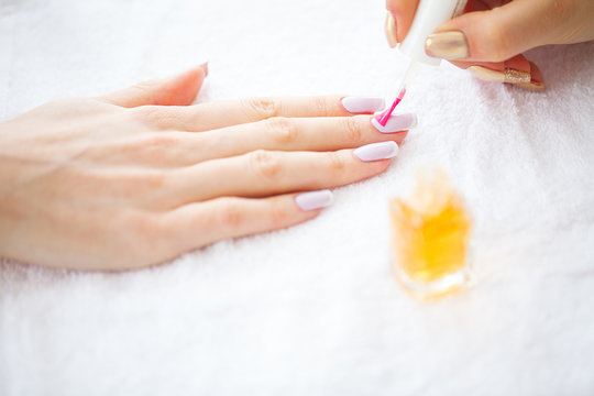 Woman hands in a nail salon receiving a manicure procedure. SPA manicure