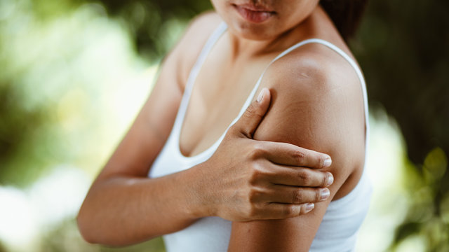Woman with pain in shoulder and upper arm , Health Care Concept