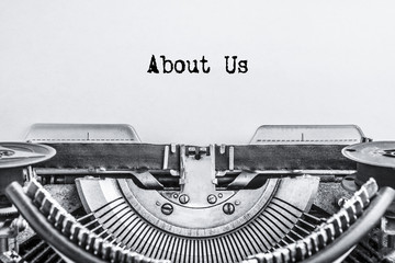 About Us, the text is typed on a vintage typewriter. ink on an old paper