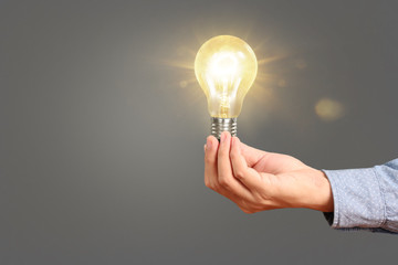 hand holding  light bulb with energy