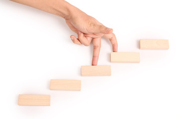 Hand liken business person stepping up  toy staircase