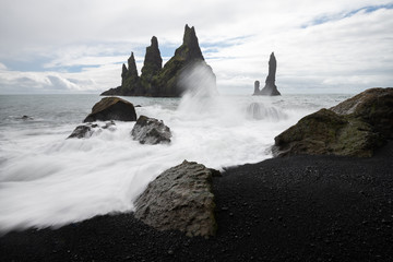 Fototapeta na wymiar Basalt rock formations Troll toes on black beach. Reynisdrangar, Vik, Iceland