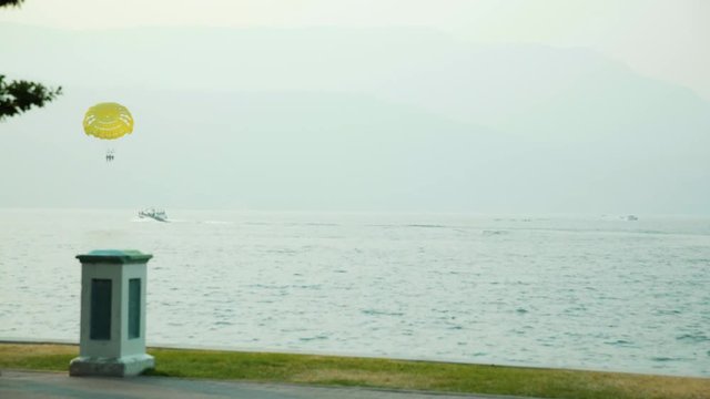 Parasailers on the Okanagan Lake in smokey conditions