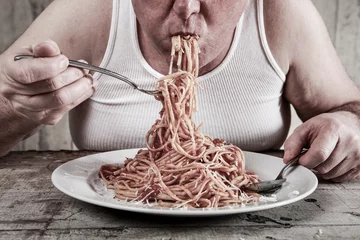 Rolgordijnen Man eating spaghetti, overeating adult. © soupstock
