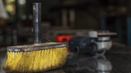 Yellow cleaning broom, work room and home, blurred background sander  
