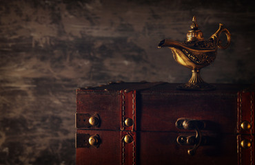 Image of magical mysterious aladdin lamp over black background. Lamp of wishes.