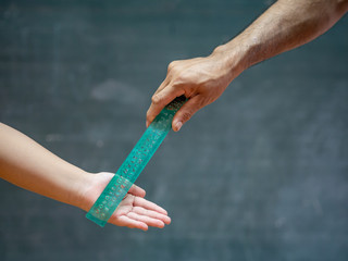 teacher use the ruler hit the kid's hand for punishment.