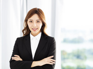 smiling young business woman standing in office
