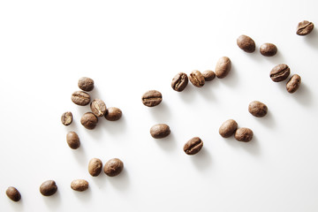 roasted coffee beans poured from clear glass