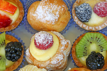 background of mignon pastries stuffed with creams and fruit