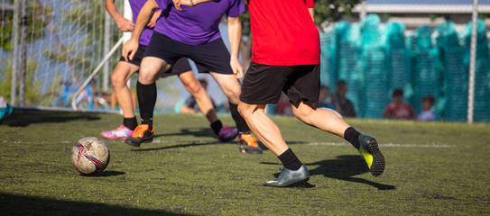 Football soccer players playing in a football field on a sunny day, banner.
