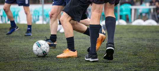 Fototapeta premium Football soccer players playing in a football field on a sunny day, banner.