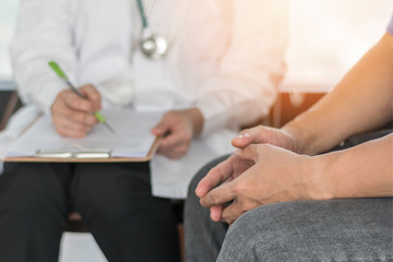 Obraz na płótnie Canvas Male patient having consultation with doctor or psychiatrist who working on diagnostic examination on men's health disease or mental illness in medical clinic or hospital mental health service center
