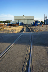 train tracks to industrial building