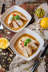 Chicken breast grilled with basmati rice on a white plate with brown sauce. Autumn menu