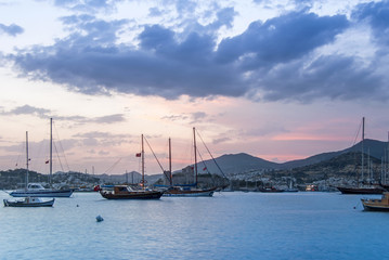 Fototapeta na wymiar Bodrum, Turkey, 27 May 2011: Sailboats at Cove of Kumbahce on Sunset