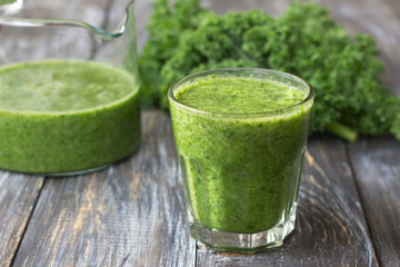 Green smoothies with kale, banana and lemon. on a wooden table. selective focus. healthy diet food