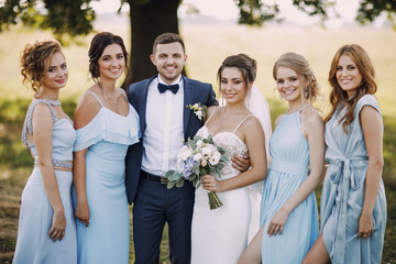 couple with bridesmaids