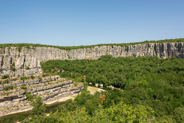 Beautiful panoramic view of the landscape with the river Ardeche, framed by rock faces and much vegetation at "Cirque des Gens" in the department Ardeche in the south of France