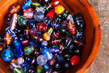Close up of a variety of fancy colorful Lampwork glass beads. Background