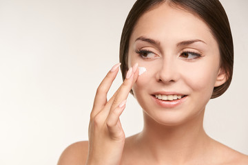 Sunscreen skin cream woman. Skincare tan girl