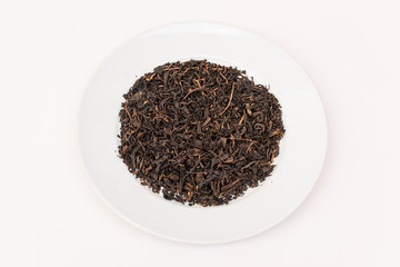 pile of dry tea leaves on white plate