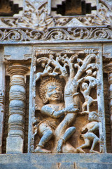 Sculpture of Bhima shaking the tree and Kauravas are falling down. Chennakeshava temple. Belur, Karnataka. An episode from Mahabharata.