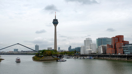 Fototapeta na wymiar City landscape with a river and a bridge. Dusseldorf, Germany
