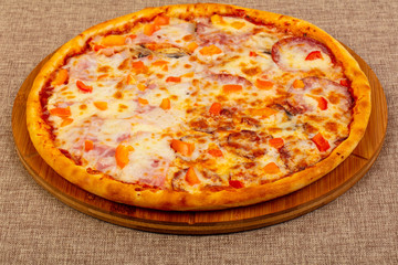 Pizza with ham and sausages