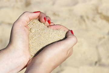 Heart shape of sand in hands, Concept of summer, love, vacation