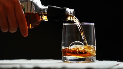 Glass with ice and scotch whiskey on wooden glass - Powered by Adobe