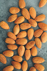 Fresh almond nuts. Food background. Top view. Toned.