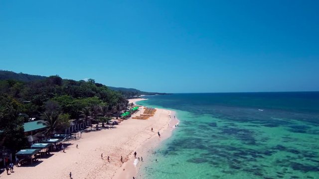 Aerial drone shots of a white sand beach with blue waters in an exotic place in the Philippines, southeast asia