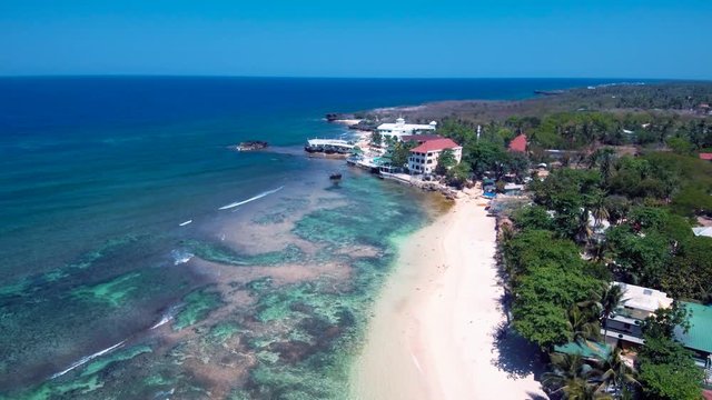 Aerial drone shots of a white sand beach with blue waters in an exotic place in the Philippines, southeast asia